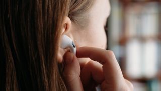 Close up of lady wearing a pair of Apple AirPods 